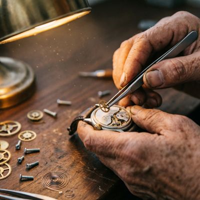 Qwen Image 2.0 Pro generated image of A hyper-realistic close-up of an elderly craftsman's weathered hands meticulo...