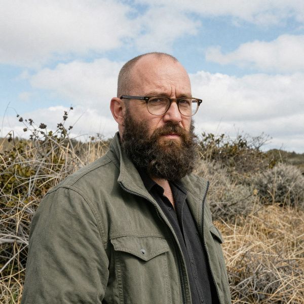 Give the person a full, thick head of natural hair with realistic texture, density, and a natural...