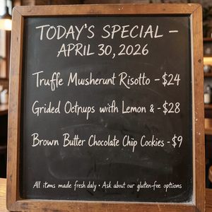 Handwritten-style chalkboard menu in a cozy café, all tex...
