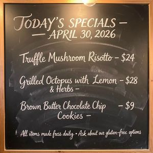 Handwritten-style chalkboard menu in a cozy café, all tex...