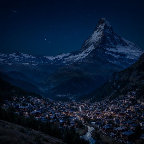 AI image generated by Reve Image 1.0, ranked #1 of 16 in the "Night Sky Transformation" arena challenge — prompt: Change the scene to night: a deep, dark sky with subtle, glistening stars visible behind the mountain.